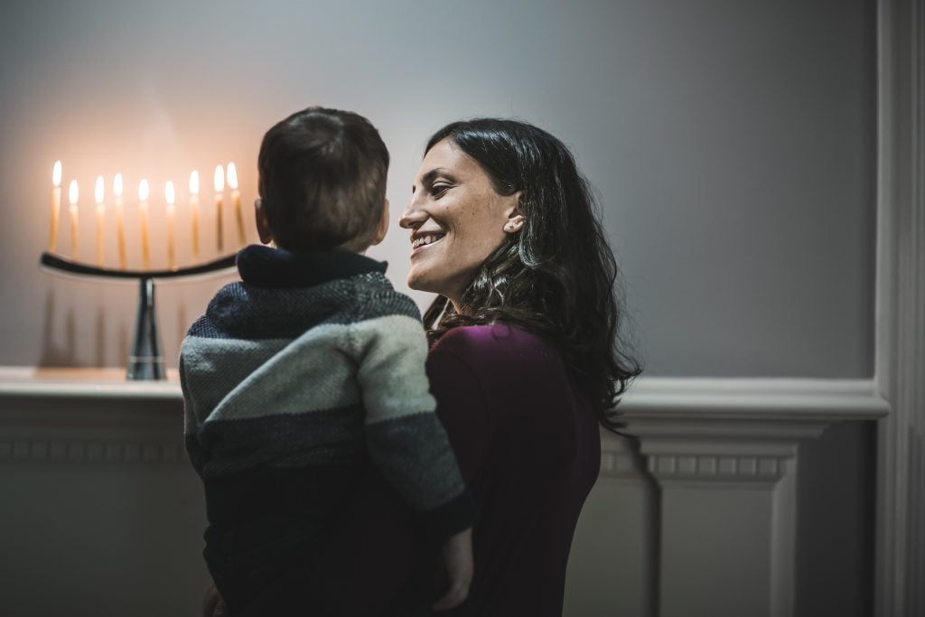 Family celebrating Hanukkah (The Good Brigade/Getty Images)