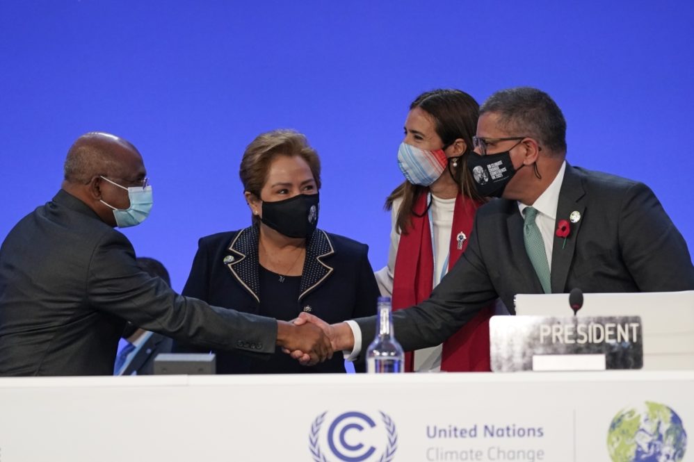 Alok Sharma, right, President of the COP26 summit shakes hands with UNGA President Abdulla Shahid as outgoing COP president Carolina Schmidt, second right, and Patricia Espinosa, UNFCCC Executive-Secretary look on during the Procedural Opening of the COP26 U.N. Climate Summit in Glasgow, Scotland. (AP Photo/Alberto Pezzali, Pool)