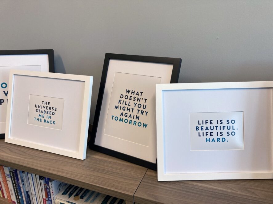 Framed sayings poking fun at the self-help movement line Kate Bowler’s “Everything Happens” podcast offices in Durham, North Carolina. RNS photo by Yonat Shimron