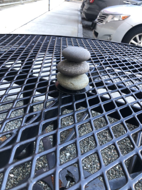 Waiting for the shuttle to St. Elizabeth's, I noticed three stacked rocks in the center of each table, reminding me of Buddha statues. Since then, whenever they fall apart or are missing a rock, I rearrange them back to Buddhas. It feels like a meditative exercise before or after suffering encountered in the hospital, these rocks as guardians. Photo courtesy