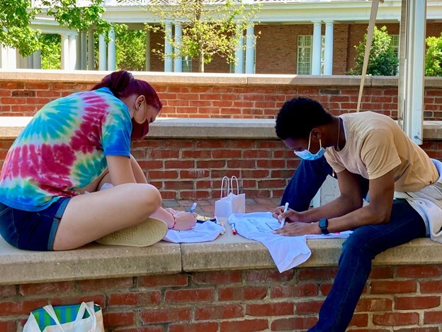Students coloring pride shirts at a Spirit and Pride event