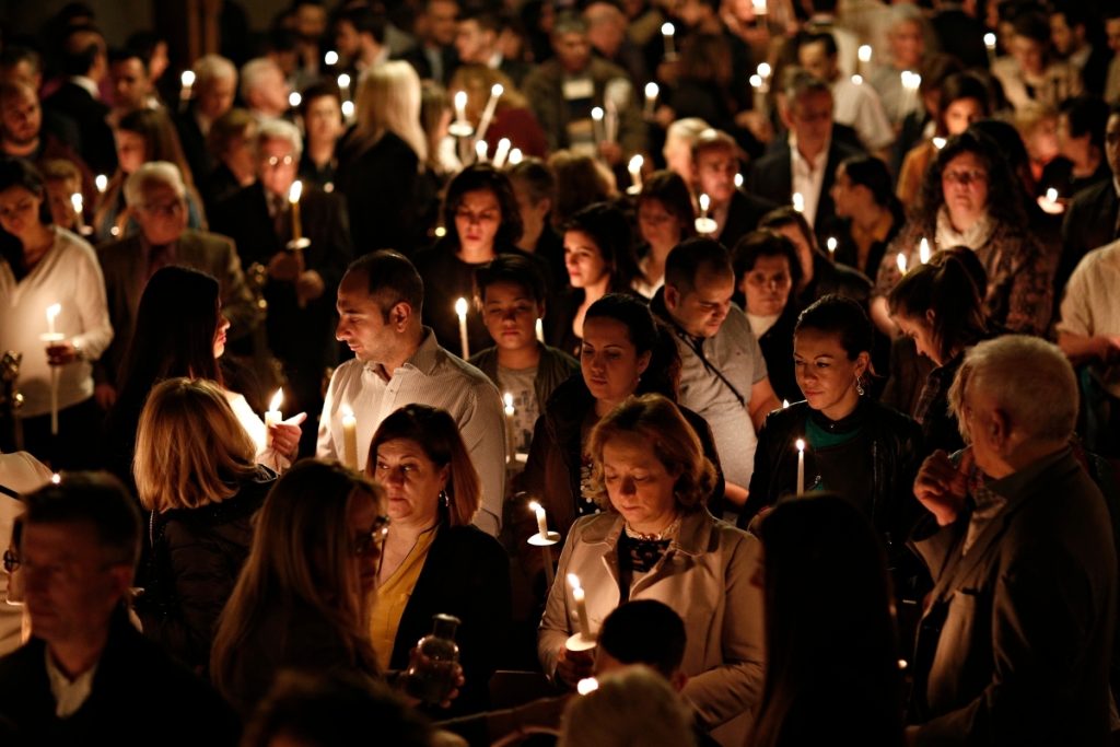 Orthodox Christians hold candles during an Easter vigil mass. (Alexandros Michailidis/Shutterstock)