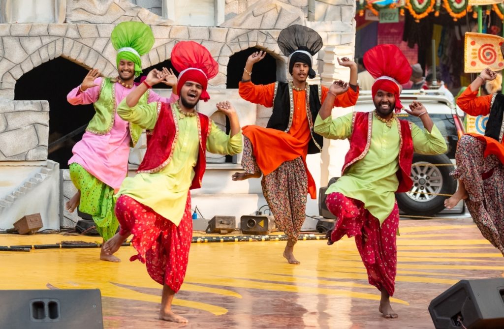 Sikh artists performing Punjabi Bhangra dance. (AbhishekMittal/Shutterstock)