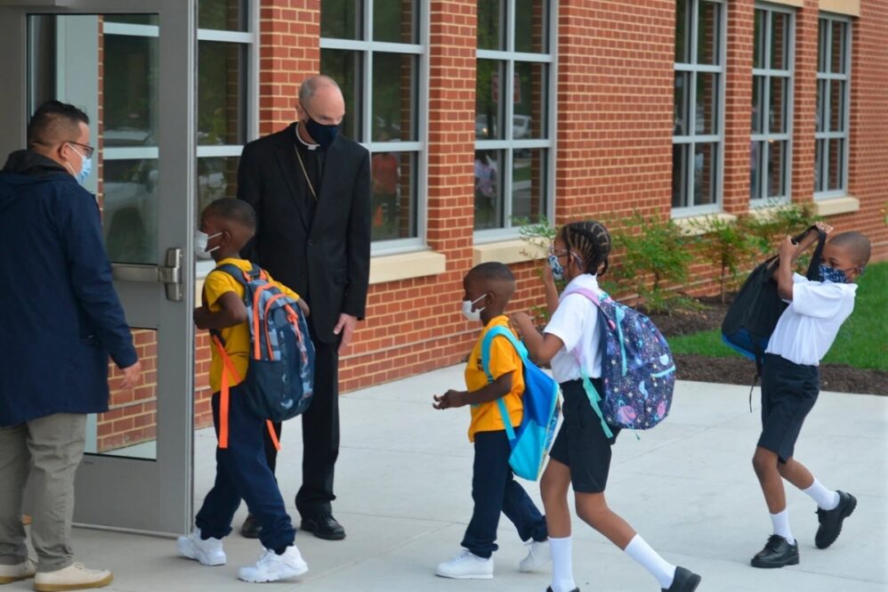 Students enter the first new Catholic school built in Baltimore in roughly 60 years with a mix of enthusiasm and first-day jitters, Aug. 2021. It’s named after Mother Mary Lange, who started a Catholic school for Black children in 1828. (AP Photo/David McFadden)
