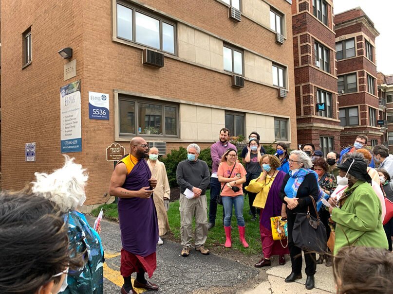 Heiwa no Bushi, center left, a BodhiChristo teacher from North Carolina, addresses the Chicago Interfaith Trolley Tour during a stop at the Claret Center. RNS photo by Bob Smietana