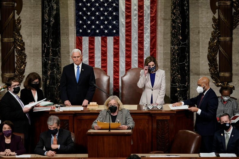 Vice President Mike Pence, left, and Speaker of the House Nancy Pelosi, D-Calif., right, read the final certification of Electoral College votes cast in November’s presidential election during a joint session of Congress after working through the night, at the Capitol in Washington, Jan. 7, 2021. (AP Photo/J. Scott Applewhite, Pool)