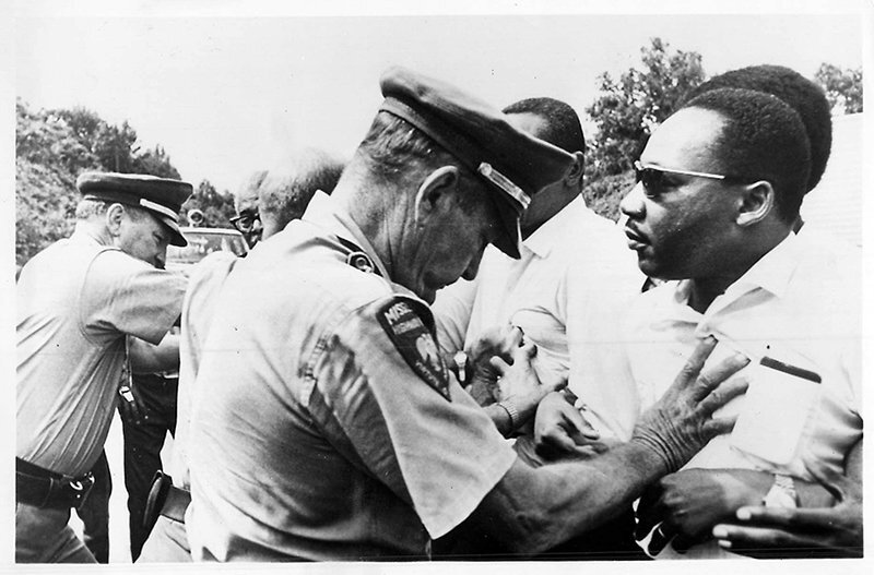 The Rev. Martin Luther King Jr., right, and other civil rights leaders, are pushed off the road as they resume a voters march begun by James Meredith. Religion News Service file photo