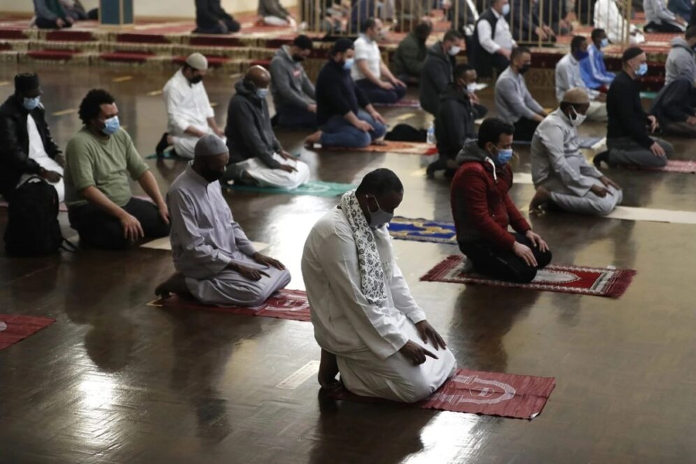 Muslims pray as they practice social distancing during an evening prayer called tarawih, marking the first eve of the holy fasting month of Ramadan, at Chicago’s Muslim Community Center on April 12, 2021. (AP Photo/Shafkat Anowar)