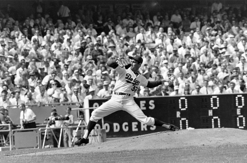 – In this Oct. 6, 1966 file photo, Los Angeles Dodgers’ Sandy Koufax pitches against the Baltimore Orioles in game two of the World Series baseball game in Los Angeles. In 1965, Koufax didn’t pitch the Dodgers’ Series opener at Minnesota because of Yom Kippur and lost to Jim Kaat the following day. Koufax pitched a four-hit shutout on three days’ rest to win Game 5, then came back with a three-hit shutout on two days’ rest to win Game 7. (AP Photo/File)