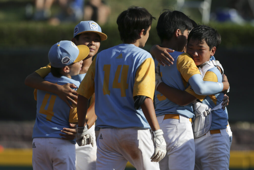 SOUTH WILLIAMSPORT, PENNSYLVANIA - AUGUST 28: Players from the West Region team from Honolulu, Hawaii celebrate after winning against the Caribbean Region team from Willemstad, Curacao 13-3 at Little League International Complex on August 28, 2022 in South Williamsport, Pennsylvania. (Photo by Joshua Bessex/Getty Images)