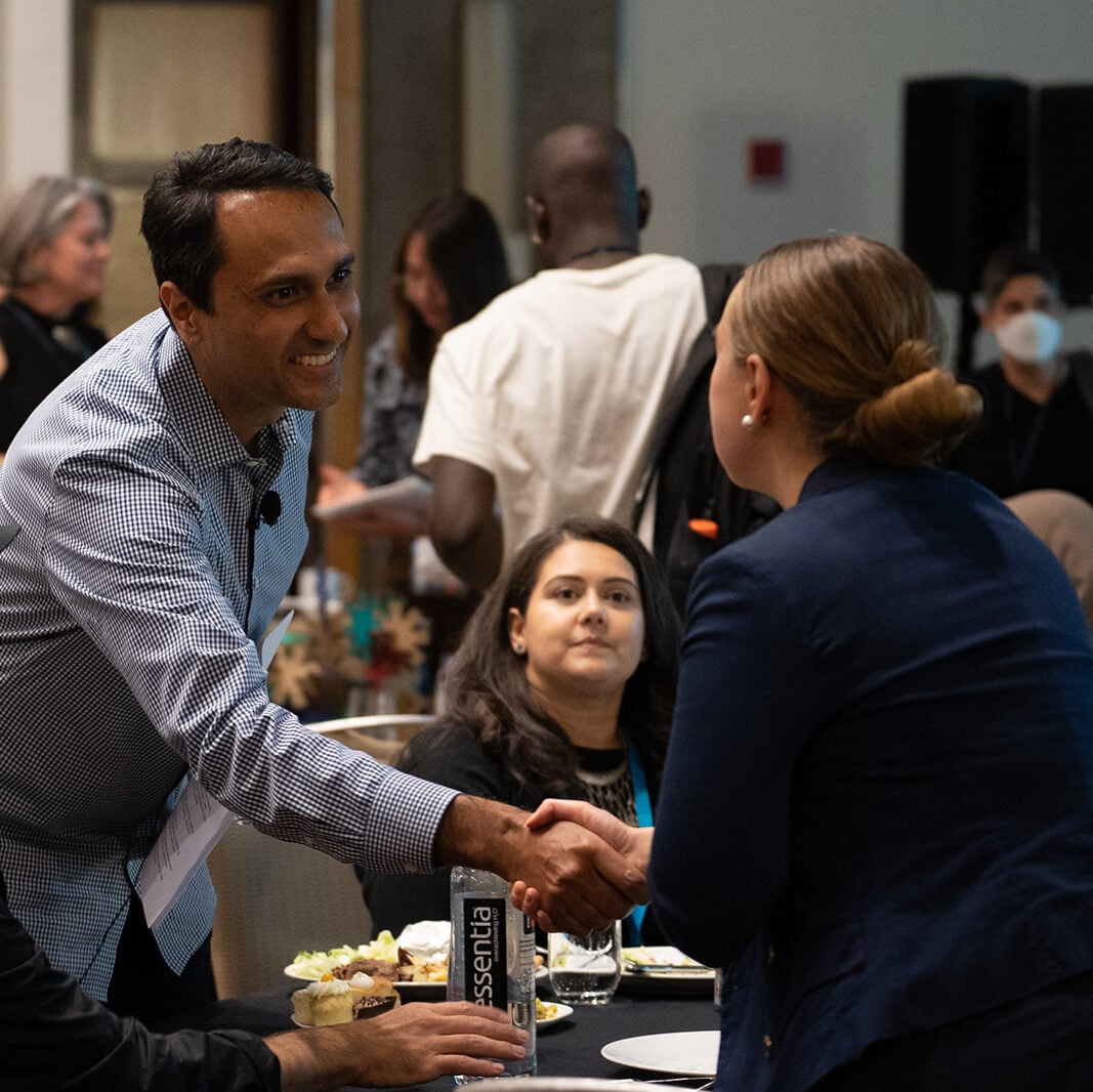 Eboo Patel shaking a student's hand at the Interfaith Leadership Summit 2022.