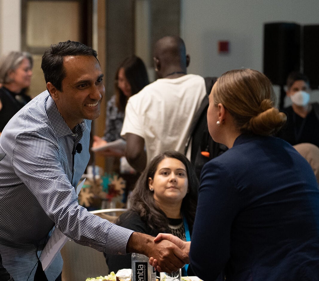 Eboo Patel shaking a student's hand at the Interfaith Leadership Summit 2022.