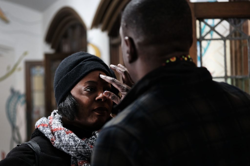 NEW YORK, NEW YORK - MARCH 06: Roody Chatelain,
a worshipper at the Church of the Village, administers a glitter ash cross on a forehead during a service at the historic church that serves all, including members of the LGBTQ community on March 06, 2019 in New York City. (Photo by Spencer Platt/Getty Images)