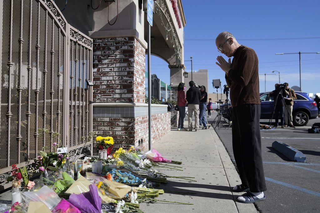 Kenny Loo, 71, prays outside Star Ballroom Dance Studio for the victims killed in Saturday's shooting in Monterey Park, Calif., Monday, Jan. 23, 2023. Authorities searched for a motive for the gunman who killed multiple people at the ballroom dance studio during Lunar New Year celebrations, slayings that sent a wave of fear through Asian American communities and cast a shadow over festivities nationwide. (AP Photo/Jae C. Hong)