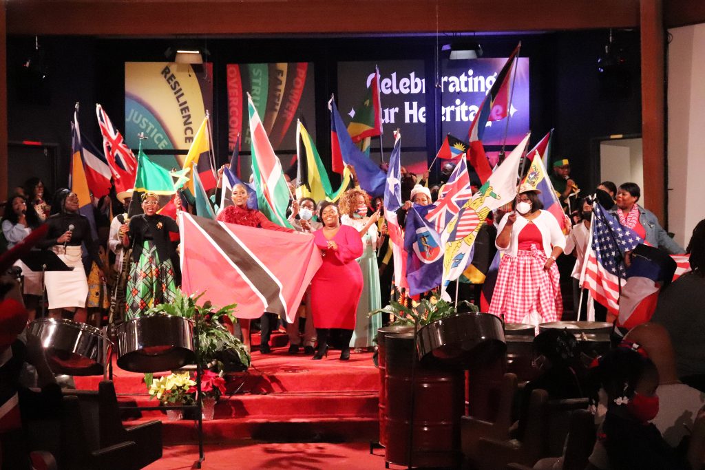 Flag bearers representing different countries stand at the front of Metropolitan Seventh-day Adventist Church after processing into the sanctuary for “Caribbean Sabbath” at the Hyattsvile, Maryland, church on Feb. 18, 2023. RNS photo by Adelle M. Banks