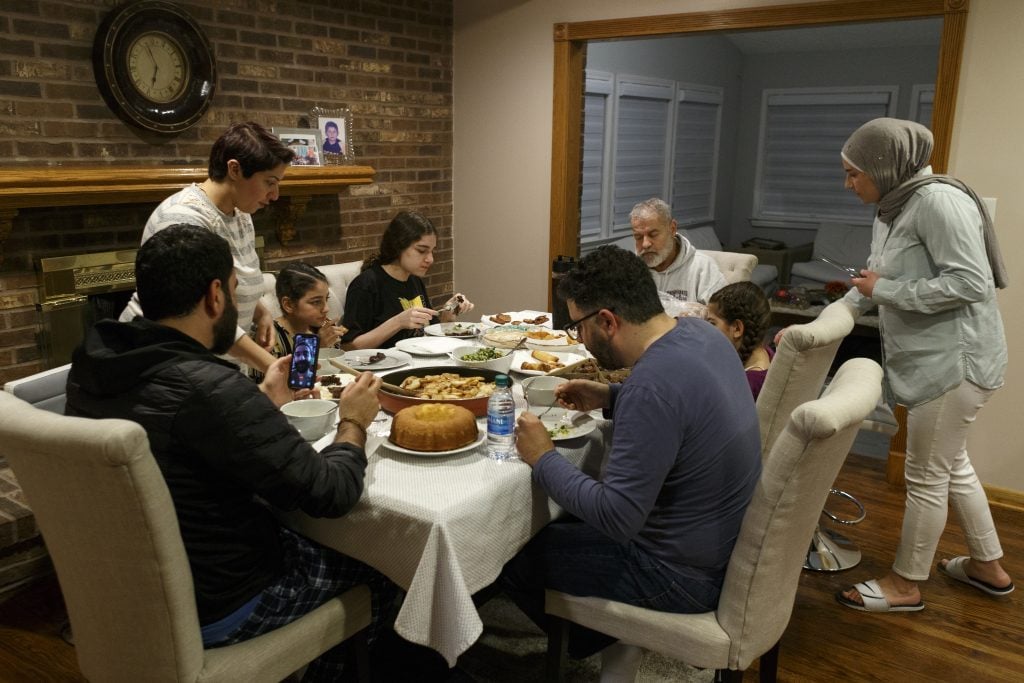 DEARBORN, MI - APRIL 24: Abbas Al Haj Ahmed talks with his cousin Adam Bazzi over a video call while their family shares a meal and breaks fast on the first full day of Ramadan on April 24, 2020 in Dearborn, Michigan. (Photo by Elaine Cromie/Getty Images)