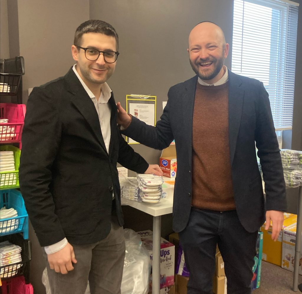 Imam Durić and Rabbi Bair at the CNY Diaper Bank. Durić and Bair gathered ten Muslim and ten Jewish students to package bags of diapers for parents in Central New York. Photo courtesy of Syracuse University
