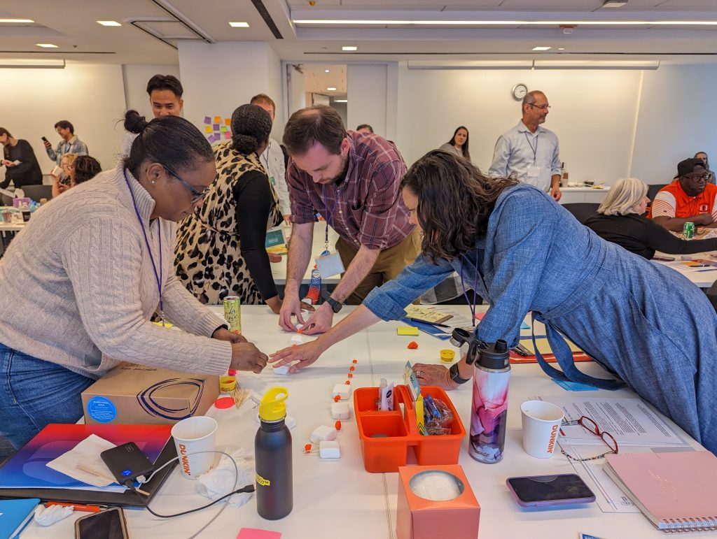Groups working together on project at Team Up training in Chicago, May 2023 (Photo credit: Becca Hartman-Pickerill)