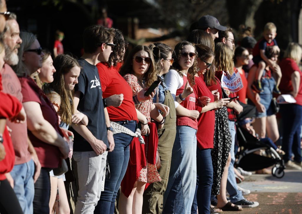 NASHVILLE, TENNESSEE - APRIL 18: Protestors participate in a demonstration of linking arms in support of gun control laws sponsored by Voices for a Safer Tennessee near Vanderbilt University on April 18, 2023 in Nashville, Tennessee. (Photo by Jason Kempin/Getty Images)