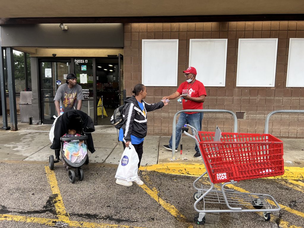Elder Richard Daniel, right, of Greater Love Praise and Worship Missionary Church, passes out voting literature while canvassing at a grocery store with Faith Community United in Cleveland, Ohio, Monday, Aug. 7, 2023. RNS photo by Kathryn Post