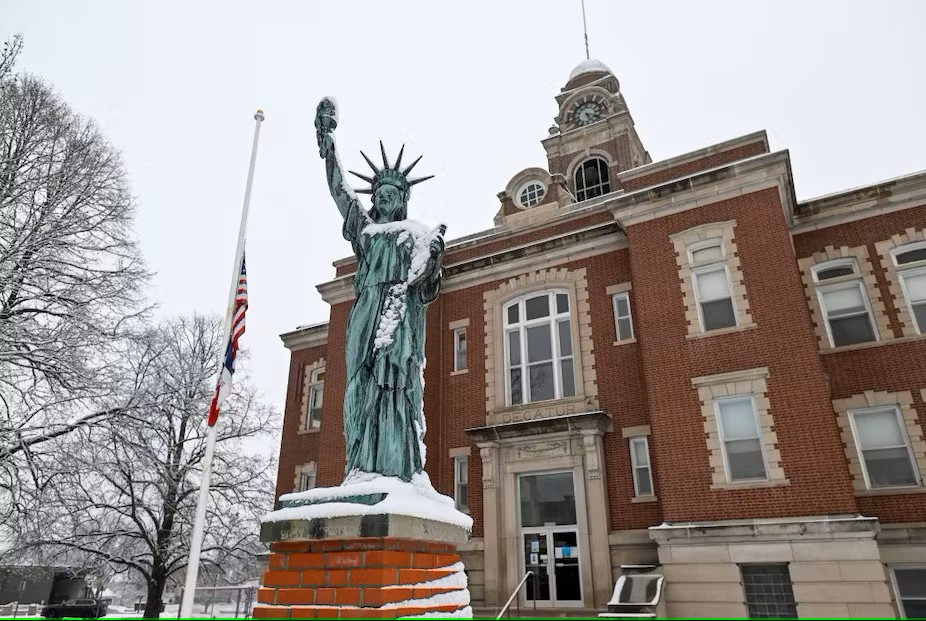Snow covers the replica of the Statue of Liberty outside the Decatur County Courthouse in Leon, Iowa. Joshua Lott/The Washington Post via Getty Images.  Republished under a Creative Commons license.