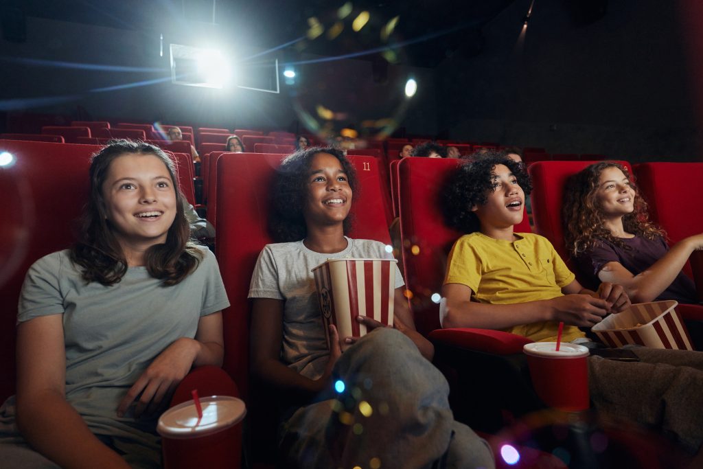 Group of friends watching a movie in the movie theather. (skynesher/Getty Images)