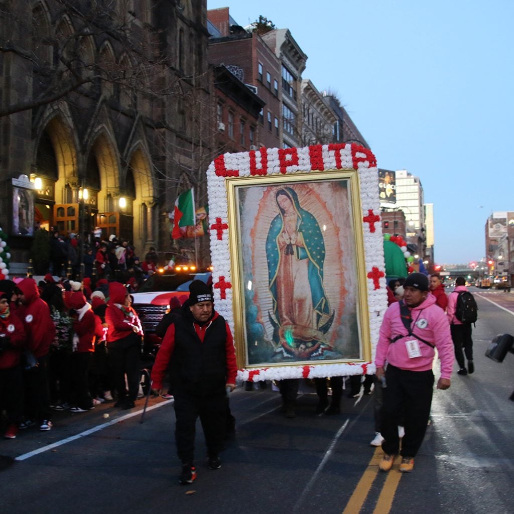 People line up outside of St. Bernard Church before a procession to St. Patrick's Cathedral for the Feast of Our Lady of Guadalupe in New York City.