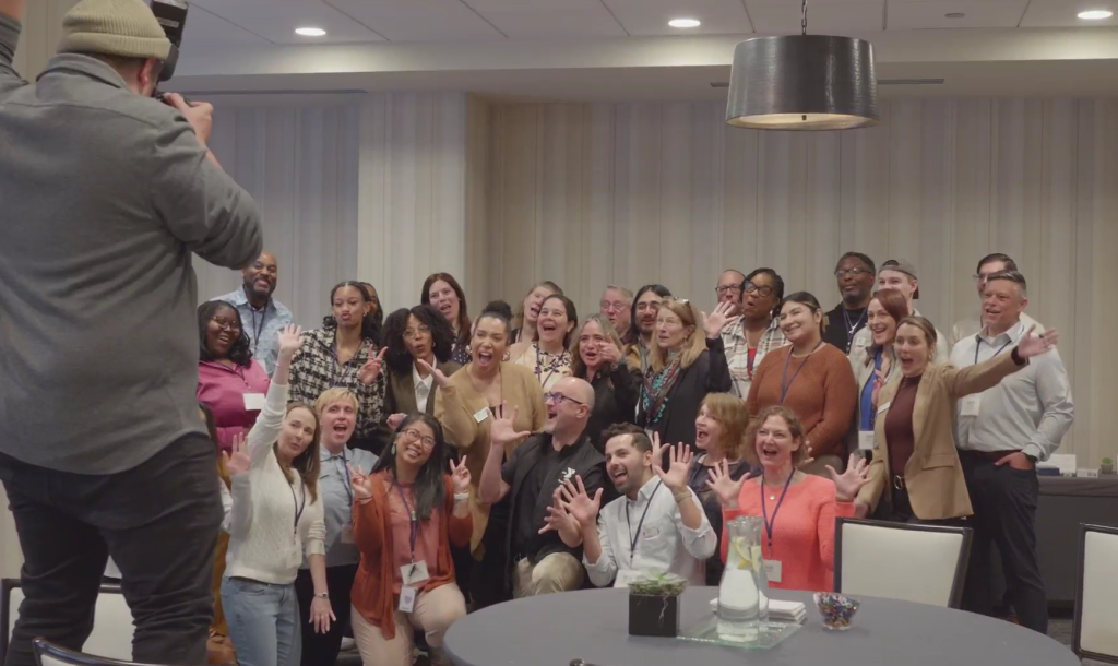 Team Up convening attendees pose for a photograph at the Kimpton Gray Hotel  in Chicago, IL. (Video Screengrab)