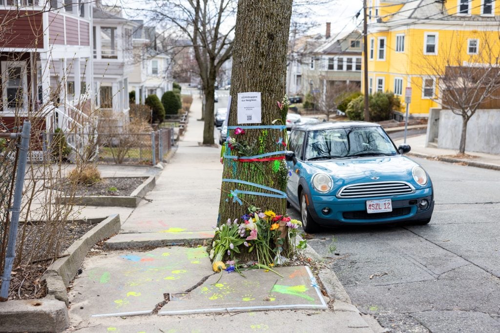 SOMERVILLE, MASSACHUSETTS - MARCH 27: Signage and flowers are placed on a tree next to where ICE agents apprehended Tuft University graduate student Rumeysa Ozturk on March 27, 2025 in Somerville, Massachusetts.  Ozturk was arrested for purported activities related to terrorist organizations amid the Trump administration's immigration crackdown.  (Photo by Scott Eisen/Getty Images)