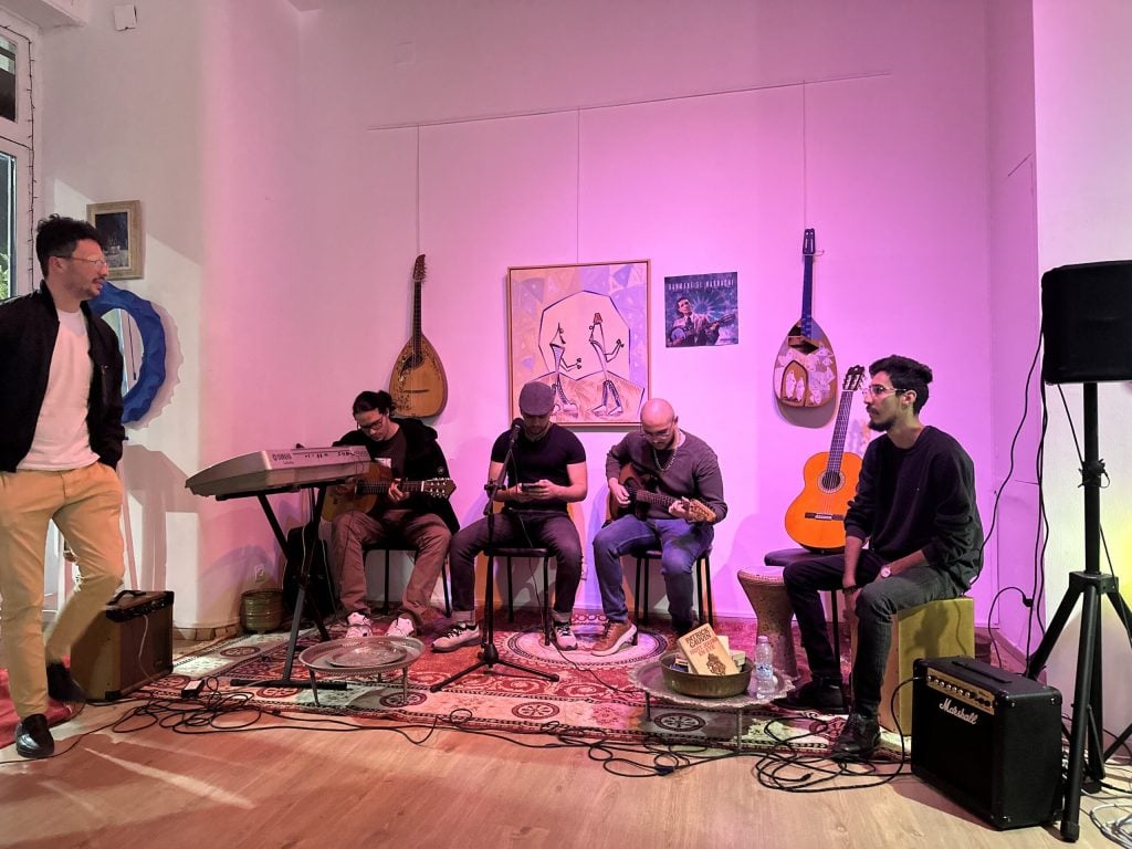 Akram Ghanemi, far right, plays Chaabi music with three other young Algerian musicians at El Medrab gallery during Ramadan, March 1, 2025, in Algiers, Algeria. (Photo by Audrey Thibert for RNS).
