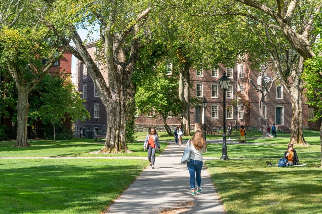 PROVIDENCE, RI/USA - SEPTEMBER 30, 2019:   Unidentfied individuals, and University Hall  on the campus of Brown University. (Shutterstock/Ken Wolter)