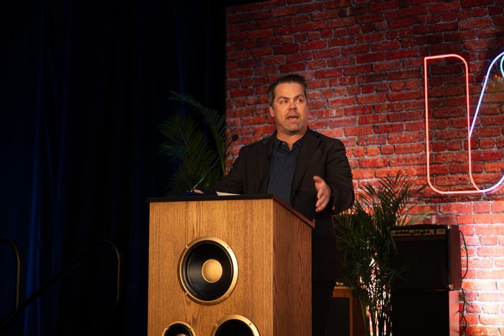 Adam Nicholas Phillips speaking at the 2025 Interfaith Leadership Summit in Chicago on August 8, 2025.