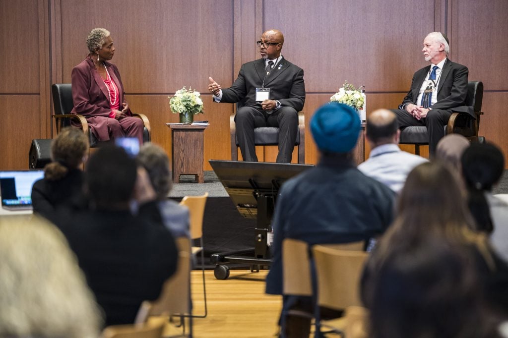 The Rev. Eric Manning, center, speaks on a panel with Rabbi Hazzan Jeffrey Myers, right, moderated by the Rev. Jacqui Lewis, left, during the 2025 RNS symposium at Trinity Commons, Wednesday, Oct. 22, 2025, in New York City. (Photo by Kisha Bari)