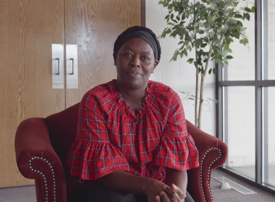 Everlyne Lagat, Community Liason for Swahili Group at the Catholic Charities Archdiocese of Santa Fe, speaks to the camera.
