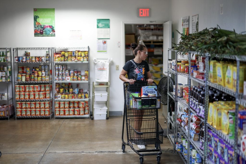 PEMBROKE PARK, FLORIDA - OCTOBER 27: Ester Pena shops at the Feeding South Florida food pantry on October 27, 2025 in Pembroke Park, Florida. (Photo by Joe Raedle/Getty Images)