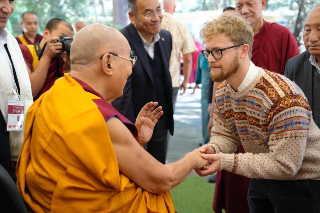 Chris Scammell, right, co-founder of the Buddhism & AI Initiative, meets the Dalai Lama, left, at the 2025 Mind & Life Dialogue— “Minds, Artificial Intelligence, and Ethics”— in Oct. 2025 in Dharamsala, India. (Photo courtesy of Chris Scammell)