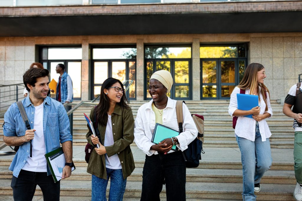 Group of young people on college campus. Daniel de la Hoz/Moment via Getty Images