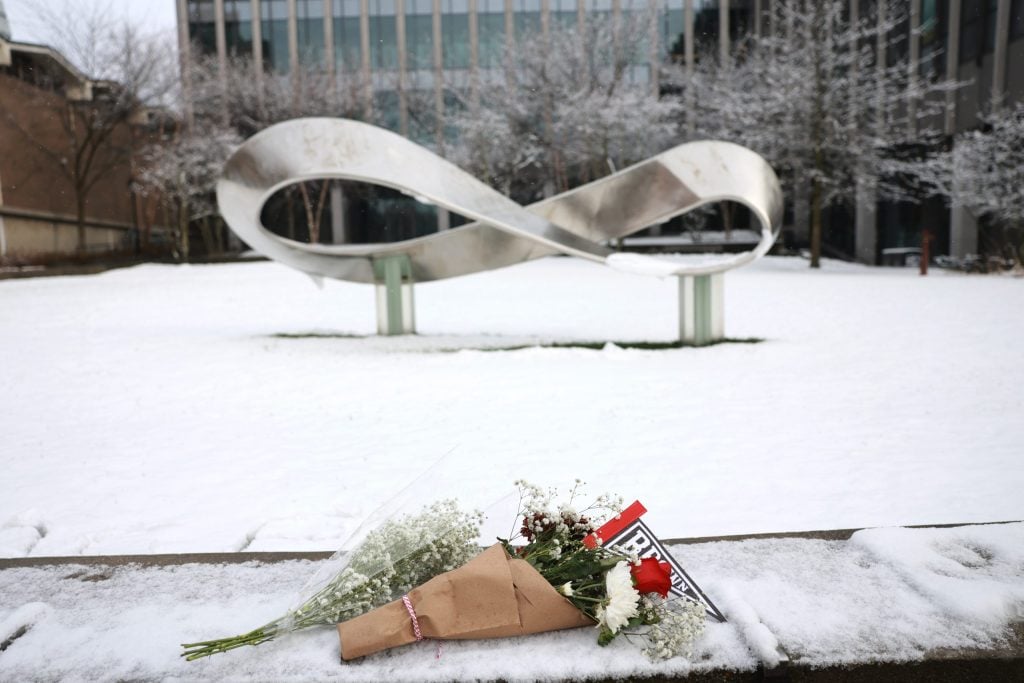 PROVIDENCE, RHODE ISLAND - DECEMBER 14: A bouquet is left outside of the engineering and physics building at Brown University, the site of a mass shooting yesterday that left at least two people dead and nine others injured, on December 14, 2025, in Providence, Rhode Island. A suspect in the shooting was detained overnight at a hotel in a nearby community following a manhunt across the prestigious university and the greater Providence area. The shooting took place around 4 p.m. on Saturday as students were preparing for exams and the holiday break. (Photo by Spencer Platt/Getty Images)