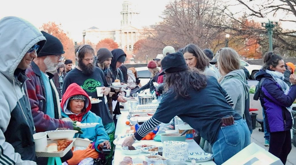 People receive free food and gear from Mutual Aid Monday volunteers on Nov. 17, 2025, near CIty Hall in Denver. (RNS photo/Fiona Murphy)