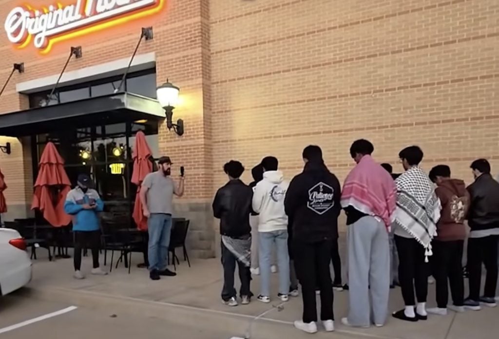 Three men disrupt Muslim teenagers offering their evening prayer outside the Original Mocha coffee house in Murphy, Texas. (Video screen grab)