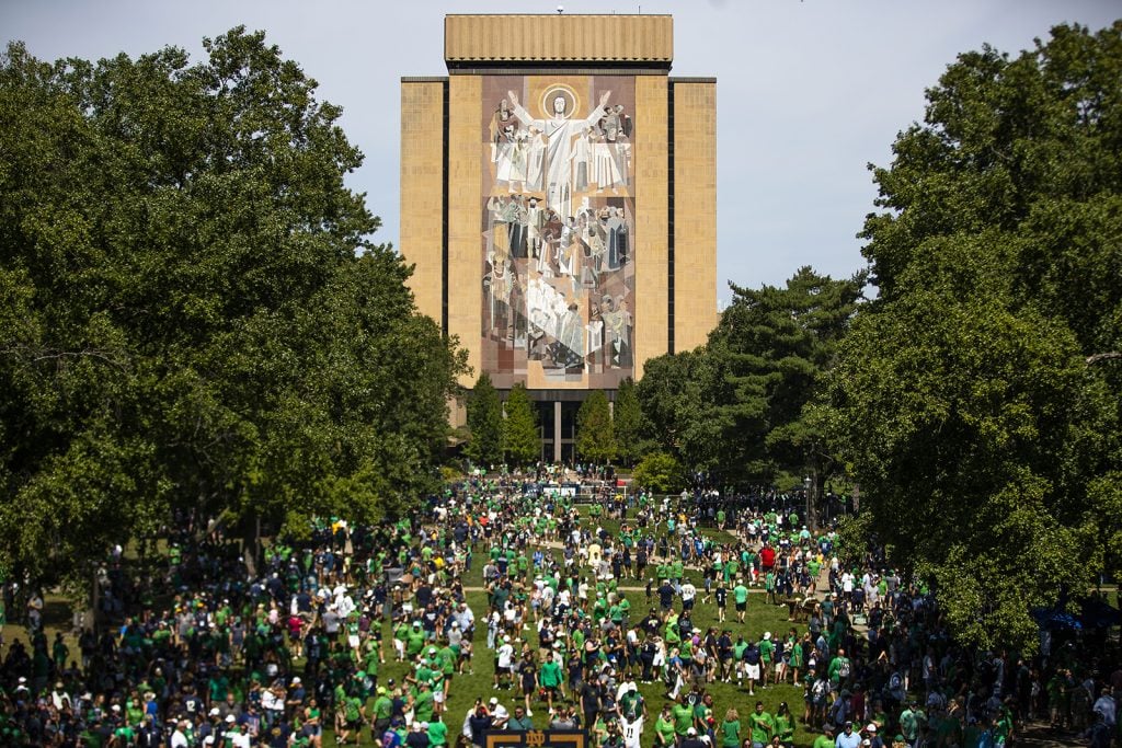FILE - Fans gather on a University of Notre Dame green space near the front of The Word of Life mural, aka "Touchdown Jesus," on the Hesburgh Library before a college football game on Sept. 2, 2023 in South Bend, Ind. (AP Photo/Michael Caterina)