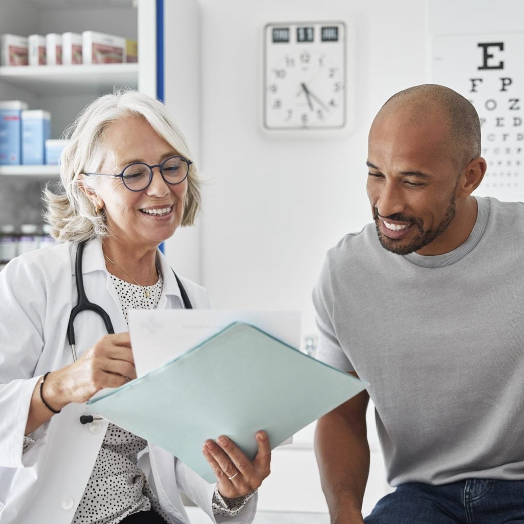 Doctor showing health reports to patient.