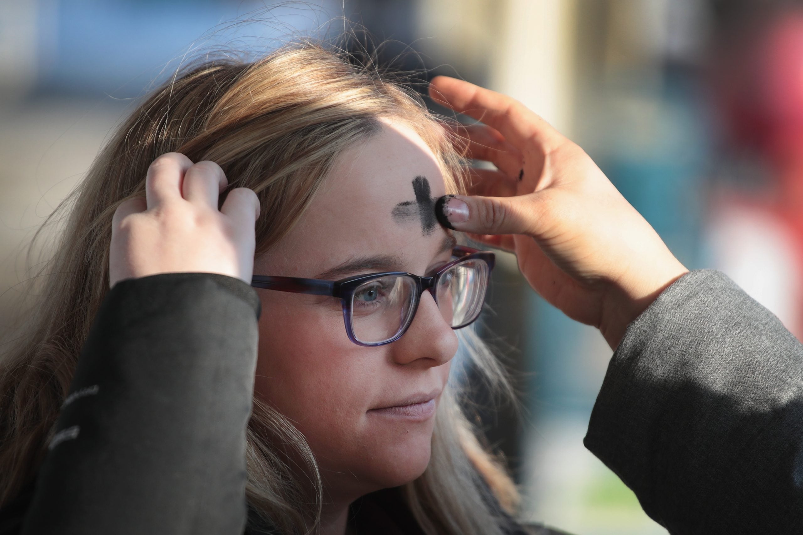 CHICAGO, IL - FEBRUARY 14: A commuter has ashes applied to her forehead in celebration of Ash Wednesday before catching a subway train in the Logan Square neighborhood on February 14, 2018 in Chicago, Illinois. Ash Wednesday is observed by Christians to mark the first day of Lent, which begins 40 days of fasting and self denial which end the Saturday before Easter. (Photo by Scott Olson/Getty Images)