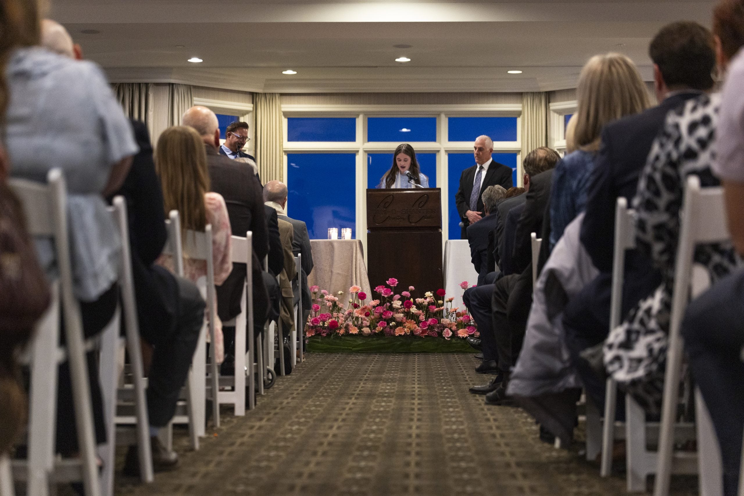WEST BLOOMFIELD, MICHIGAN - MARCH 13: Sydney Cox speaks during her Bat Mitzvah service at Tam O'Shanter Country Club on March 13, 2026 in West Bloomfield, Michigan. The ceremony was moved from Temple Israel after a gunman rammed a vehicle into the synagogue and opened fire yesterday. (Photo by Emily Elconin/Getty Images)