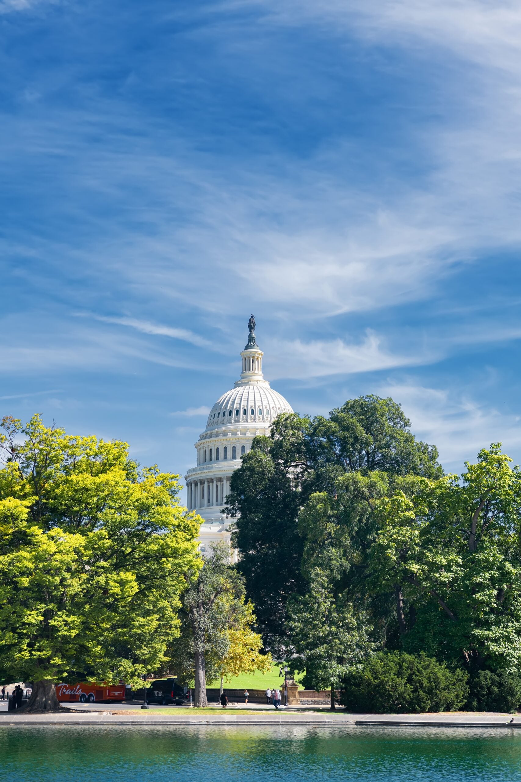 Washington DC Capitol building with trees and water in the foreground. (Kosoff)