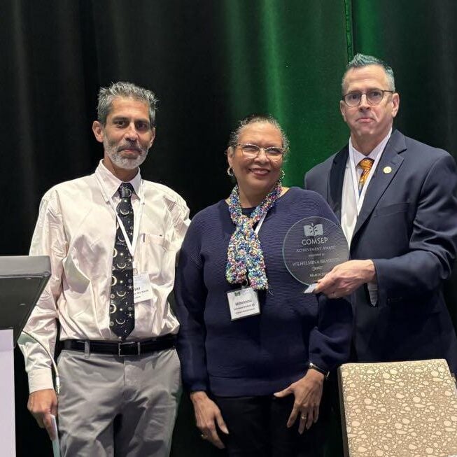 Dr. Lavjay Butani (left) with colleagues after his presentation at COMSEP's annual meeting for better health for all patients through pediatric education.