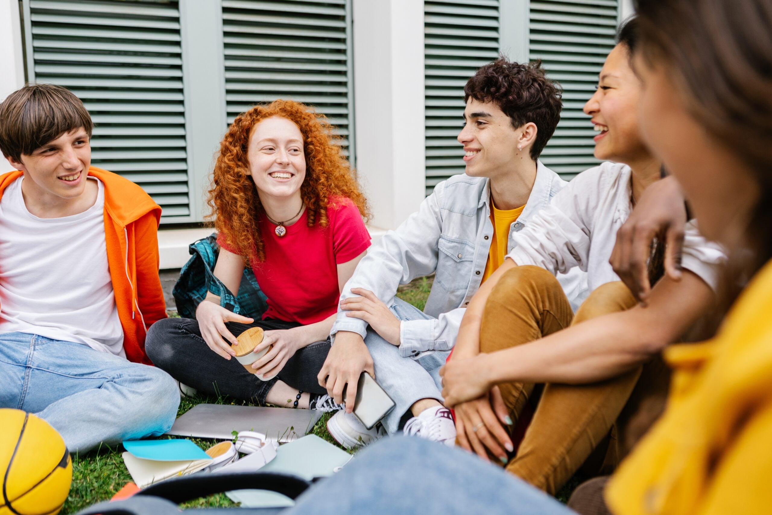 Group of teenage students hanging out at high school campus. (Xavier Lorenzo / Shutterstock)