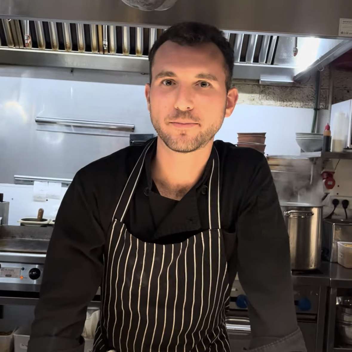 Jake Shapiro working in a kitchen in South Tel Aviv. (Courtesy)