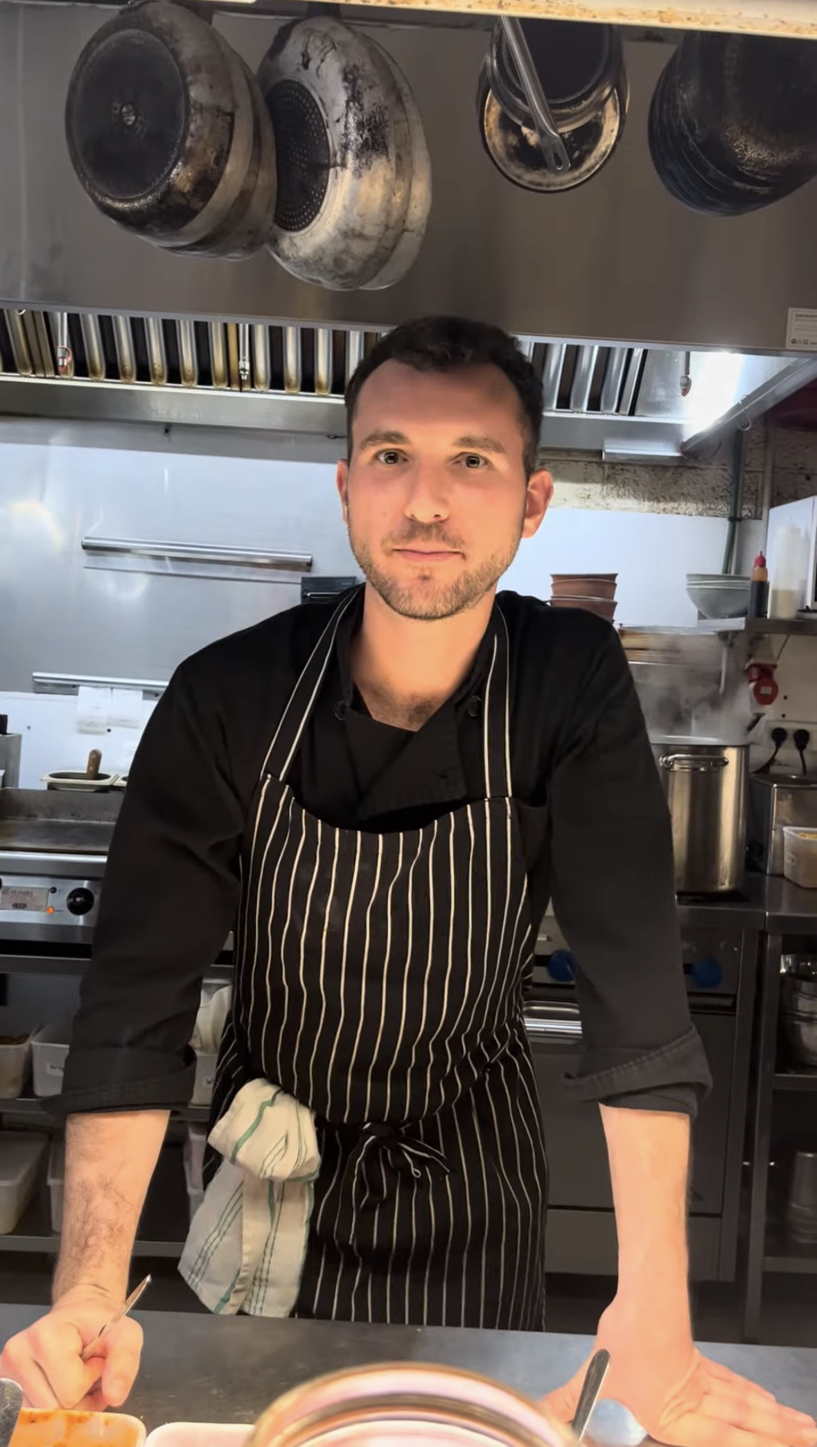 Jake Shapiro working in a kitchen in South Tel Aviv. (Courtesy)