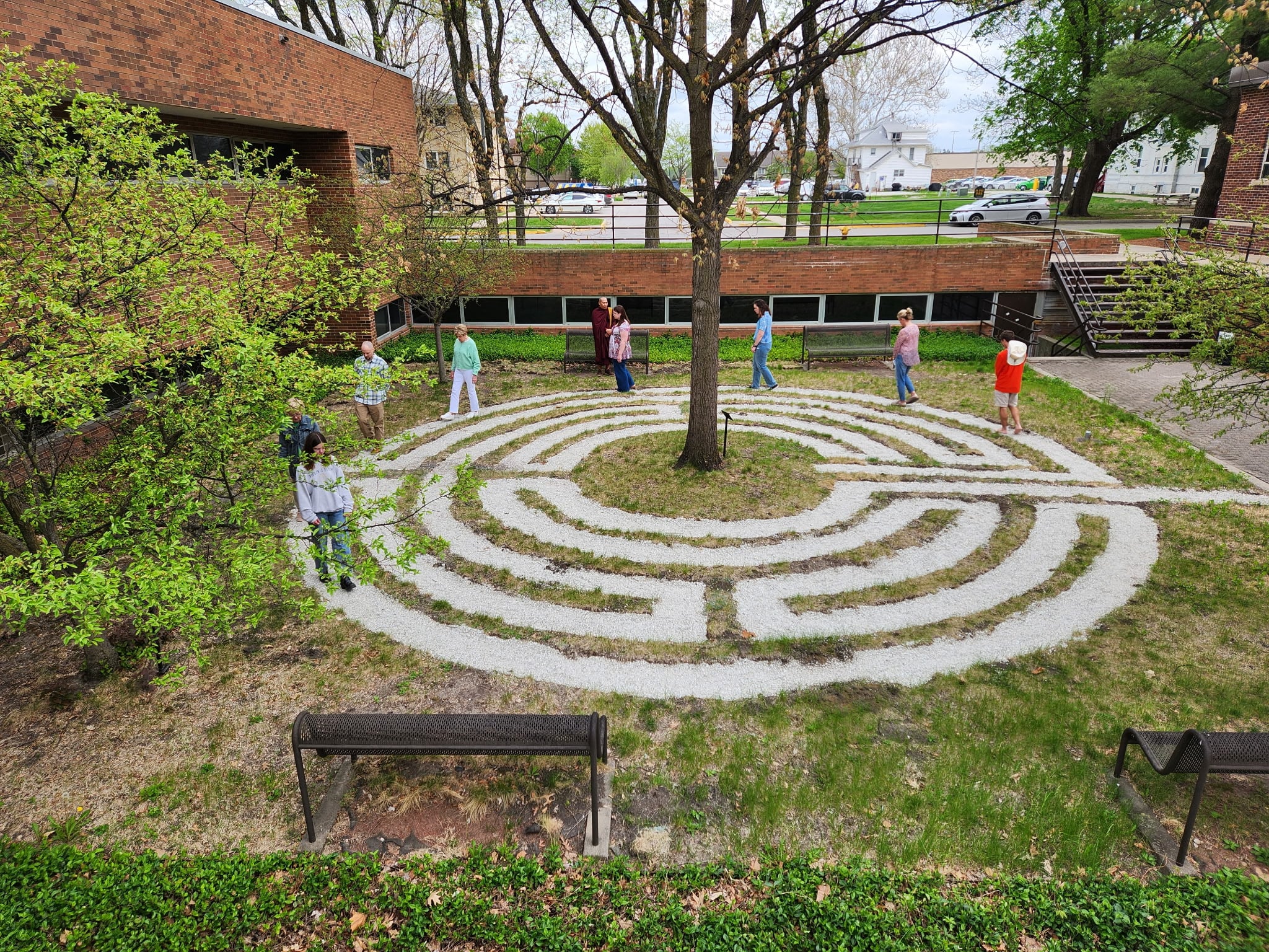 Students and community members participating in a walking mediation led by the Venerable Pamok Kha during the Grand Opening event. (Courtesy)